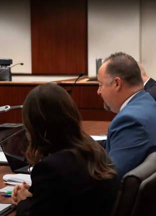 Four people sitting in front of a judge