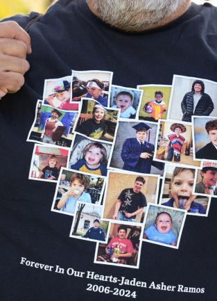 Man wearing t-shirt, it is just him holding the shirt not his face, photos of child displayed in the shape of a heart